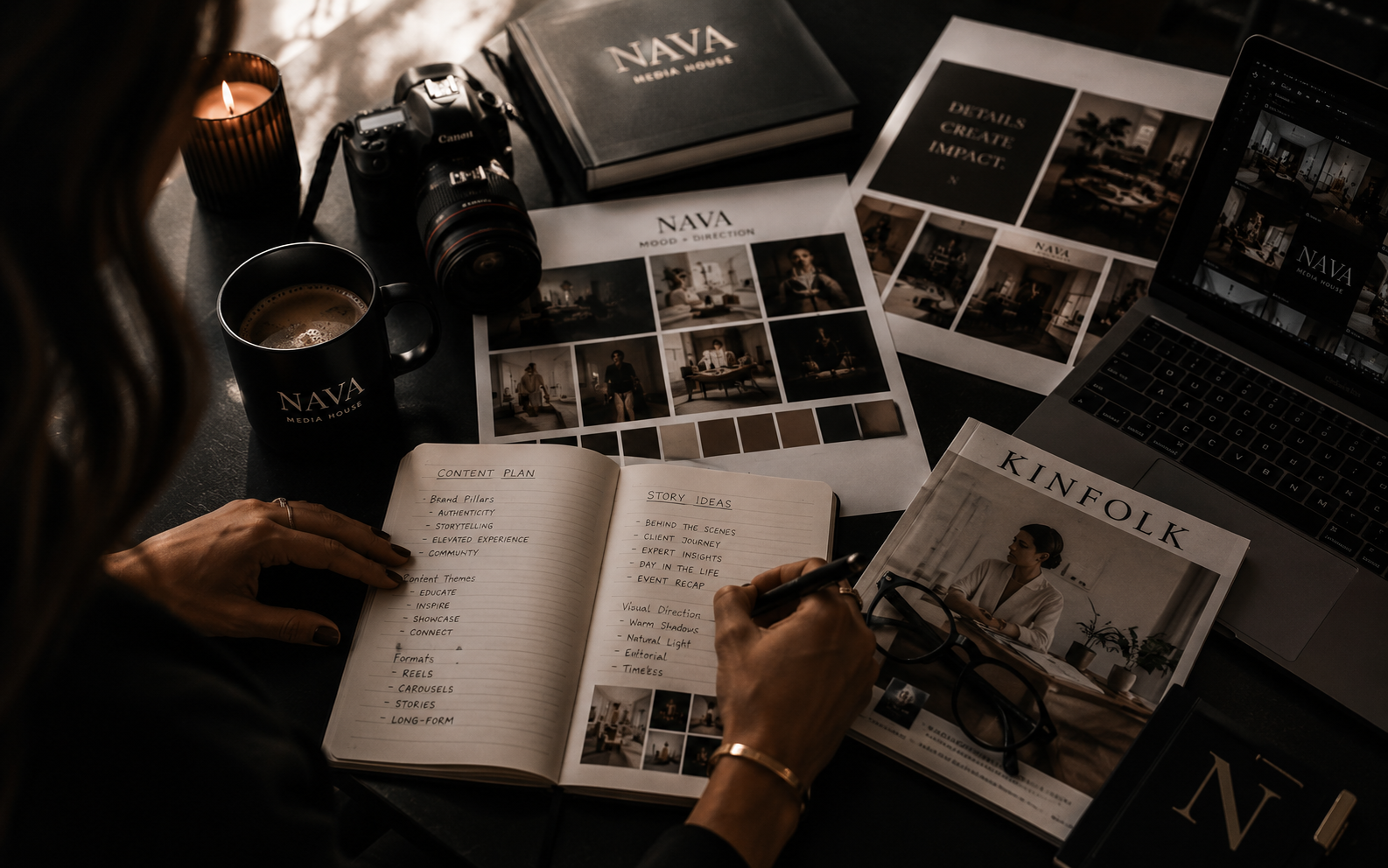 A NAVA Media House content plan open on a desk beside a camera, printed mood boards and creative direction