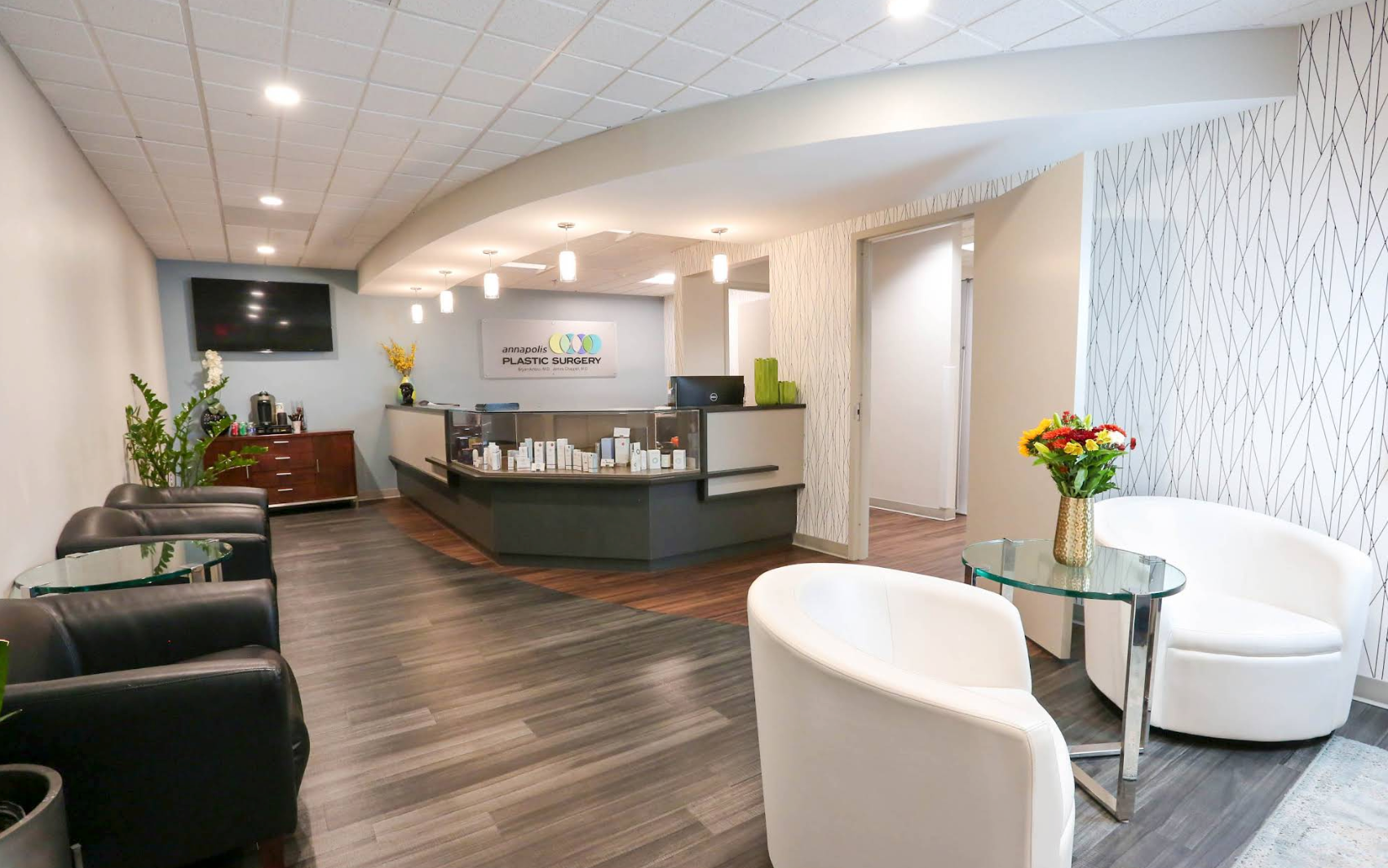 The reception and waiting area at Annapolis Plastic Surgery, with the practice's sign above the front desk